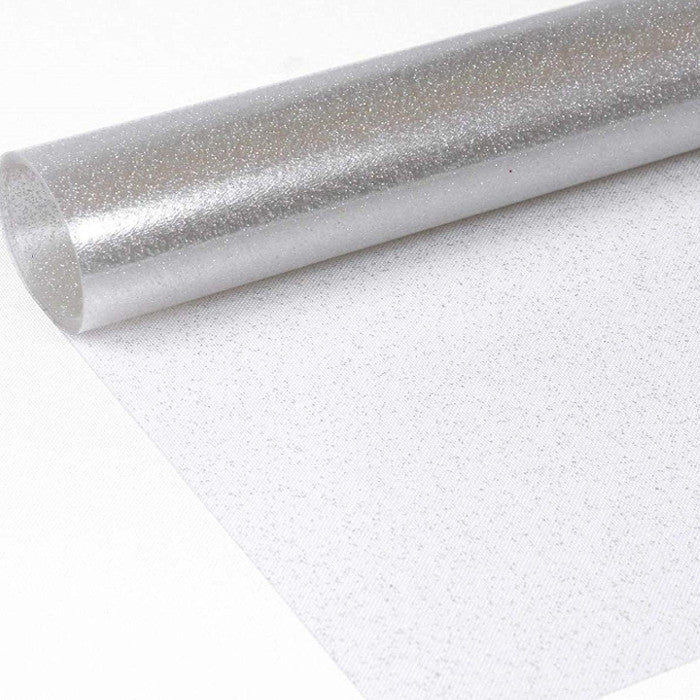 Gennemsigtig voksdug med sølv glitter.
