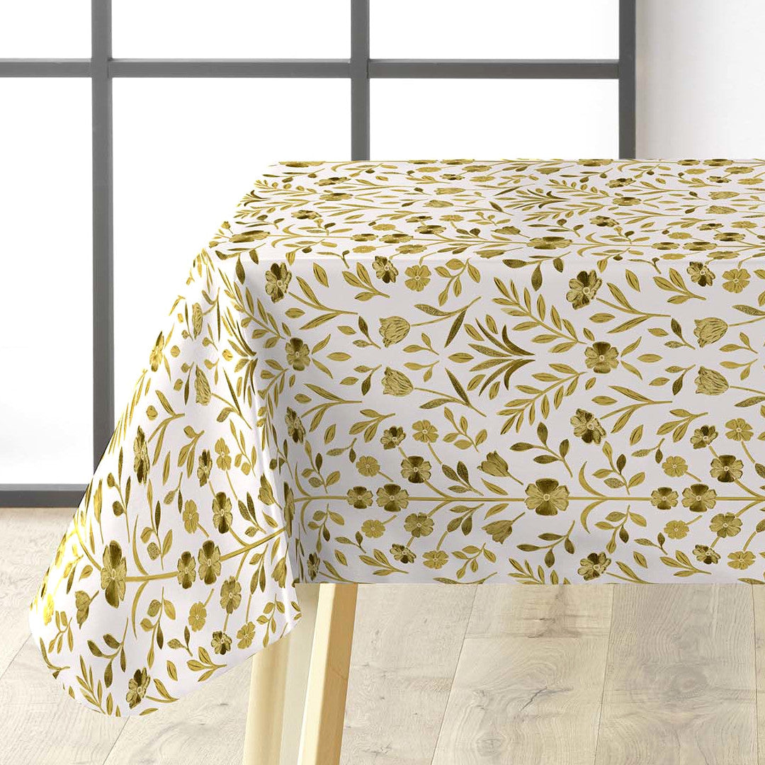 Guldflor voksdug lagt over bord med elegant mønster.