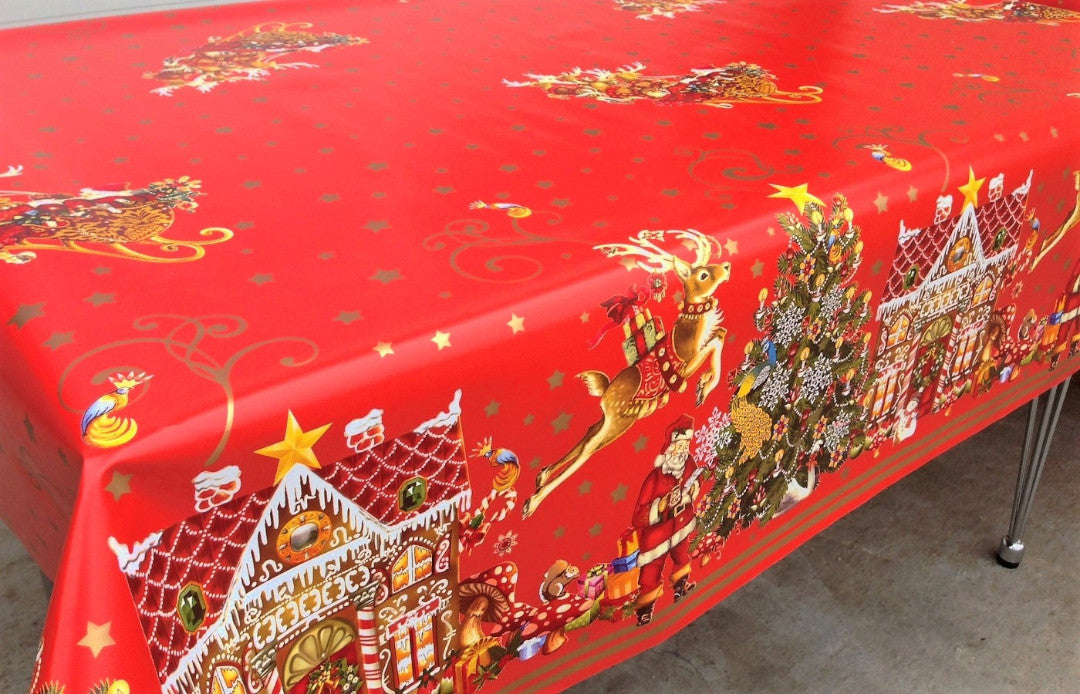 Jul i Kagehuset voksdug på spisebord med julemotiver som grantræer og kagehuse