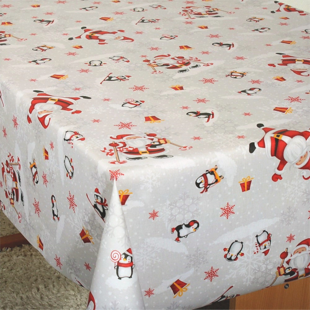 Julefest på Sydpolen juledug på bord, med sjove julemænd og pingviner.