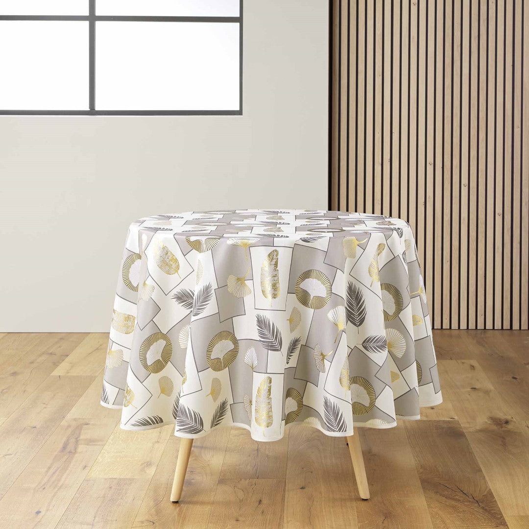 Natane Natural rund dug med bladmønster i guld og grå på en lys baggrund