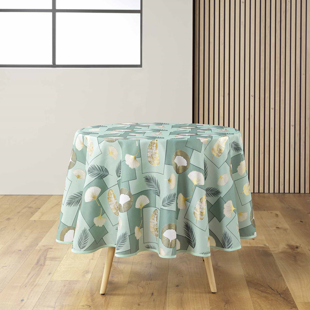 Natane Sage rund dug med bladmønster i guld og grå på en lys baggrund